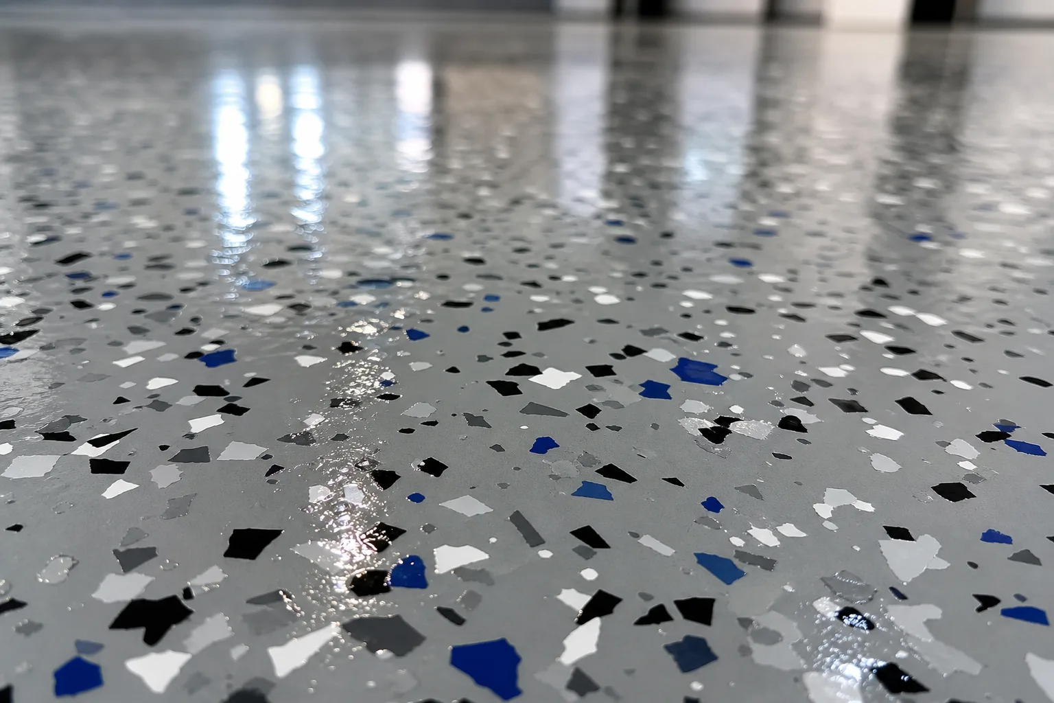 Close-up of glossy epoxy floor coating with decorative color flake